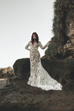 Load image into Gallery viewer, Bride with hand up in motion throwing long train of Vancouver made long sleeve wedding dress.