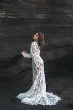 Load image into Gallery viewer, Bride with hands on rock facing away, wearing long sleeve white lace dress.