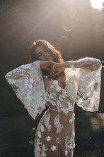 Load image into Gallery viewer, BOHO bride with both arms up to show off bell sleeves of lace wedding dress.
