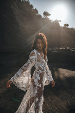 Load image into Gallery viewer, Side shot of Vancouver bride moving arm in sunlight to show details of boho wedding dress.