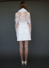 Load image into Gallery viewer, Bridal jacket from behind, with model showing lace back detail over skin.