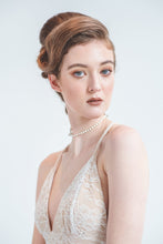 Load image into Gallery viewer, A short wedding dress with sheer lace overlay gown made from stretch lace with a low back and V front.