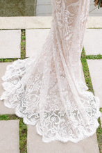 Load image into Gallery viewer, Detail shot of lace fabric on skirt fanned out of Vancouver wedding dress by Elika In Love.