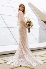 Load image into Gallery viewer, Boho Bride wearing flutter sleeve romantic lace wedding dress while holding a bridal bouquet.