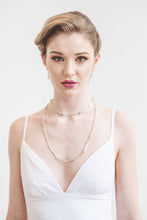 Load image into Gallery viewer, A v-neck mermaid wedding dress with lace up back detailing.