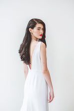 Load image into Gallery viewer, A chic low back white wedding dress with fit and flare skirt and long train for the unique and modern bride on Pinterest.