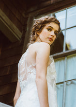 Load image into Gallery viewer, Model looking back at camera, showing back detail of sleeveless lace wedding dress.