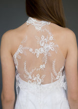 Load image into Gallery viewer, Detail shot of back of model wearing lace overlay dress over short strapless wedding dress.