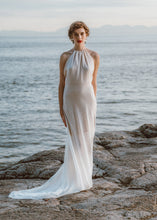 Load image into Gallery viewer, Bride standing with flowy bridal dress and halter top by custom wedding dress designer.