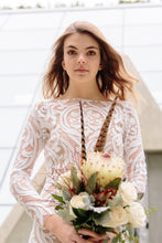Load image into Gallery viewer, Bride, posing with flowers, found her lace gown in Vancouver wedding shops.
