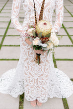 Load image into Gallery viewer, Long sleeve lace worn by bride, in a body shot holding flowers, showcasing long sleeve lace gown.