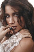 Load image into Gallery viewer, Sexy close-up shot of bride with hand on her lips, showing detail of beaded wedding dress.