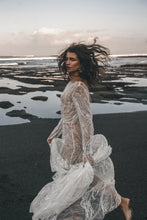 Load image into Gallery viewer, Bride running carefree on beach in long sleeve beaded lace wedding dress.
