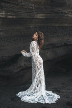 Load image into Gallery viewer, Bride with hands on rock facing away, wearing long sleeve white lace dress.
