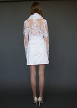 Load image into Gallery viewer, Bridal jacket from behind, with model showing lace back detail over skin.
