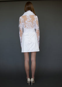 Bridal jacket from behind, with model showing lace back detail over skin.