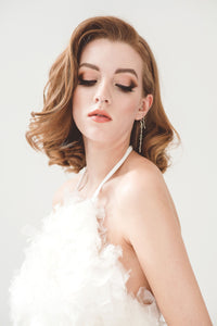 A short reception dress made from silk with lot of volume to look like feathers, for the modern bride.