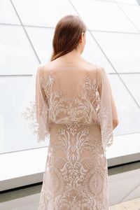 Back of bride wearing boho inspired half sleeve lace wedding dress by Elika In Love, a Vancouver wedding dress shop.