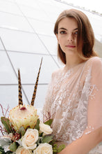 Load image into Gallery viewer, Close up of Vancouver boho bride holding flowers wearing an illusion neckline embroidered unique lace wedding dress.
