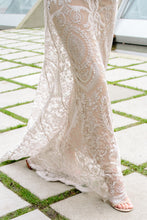 Load image into Gallery viewer, close - up of legs of bride walking in embroidered lace dress overlay on concrete.
