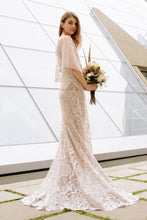 Load image into Gallery viewer, Boho Bride wearing flutter sleeve romantic lace wedding dress while holding a bridal bouquet.
