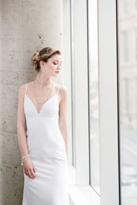A v-neck mermaid wedding dress with lace up back detailing.