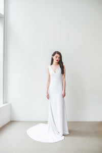 A boho chic wedding dress with sexy low V neckline, natural waist, and long train made in Vancouver.