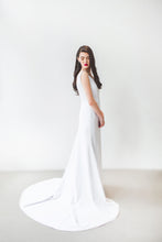 Load image into Gallery viewer, An ivory boho wedding dress with fit and flare skirt and long train. 
