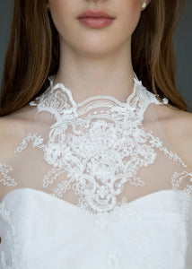 Detail shot of model's neck, wearing high neck Victorian style lace wedding dress.
