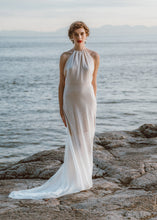 Load image into Gallery viewer, Bride standing with flowy bridal dress and halter top by custom wedding dress designer.
