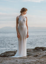 Load image into Gallery viewer, Bride standing on rock looking away wearing high neck flowy bridal gown.
