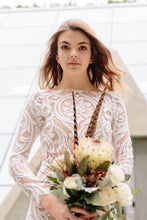 Load image into Gallery viewer, Bride, posing with flowers, found her lace gown in Vancouver wedding shops.
