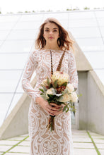 Load image into Gallery viewer, Vancouver lace wedding dress, worn by woman holding flowers, in bold lace. 
