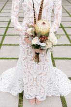 Load image into Gallery viewer, Long sleeve lace worn by bride, in a body shot holding flowers, showcasing long sleeve lace gown.

