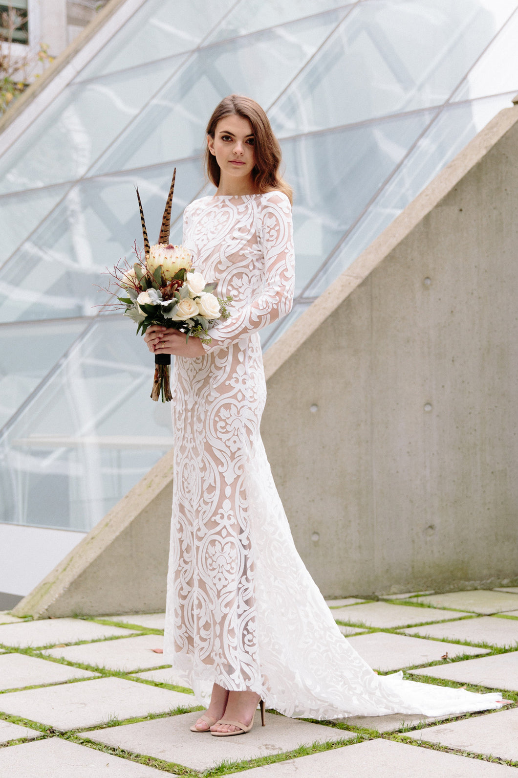 Boho lace wedding dress shot on model facing to the side in Vancouver.