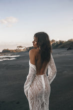 Load image into Gallery viewer, Vancouver bride shrugging shoulder of beaded fitted low back wedding dress on beach.
