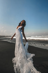 Vancouver bride dancing on beach holding skirt of low back lace wedding dresses.